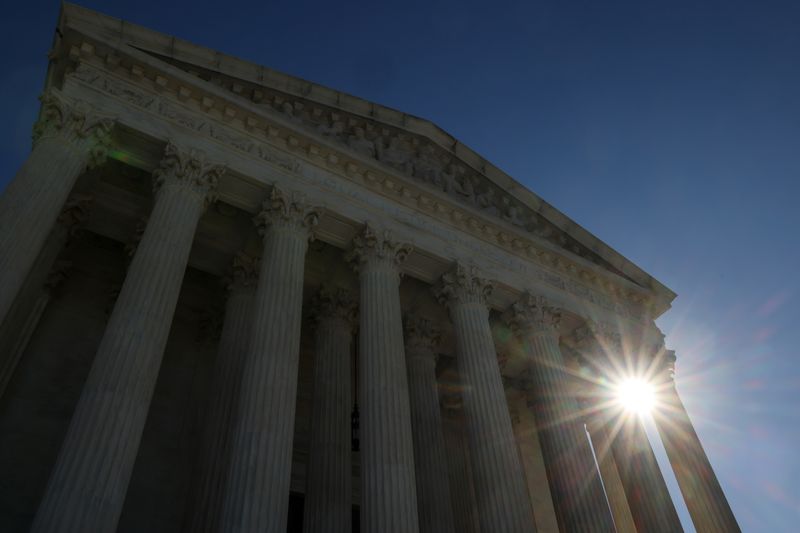 The sun rises behind the U.S. Supreme Court building the