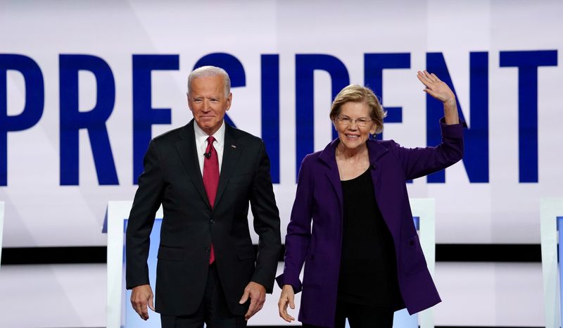 FILE PHOTO: Democratic presidential candidates Biden and Warren pose together