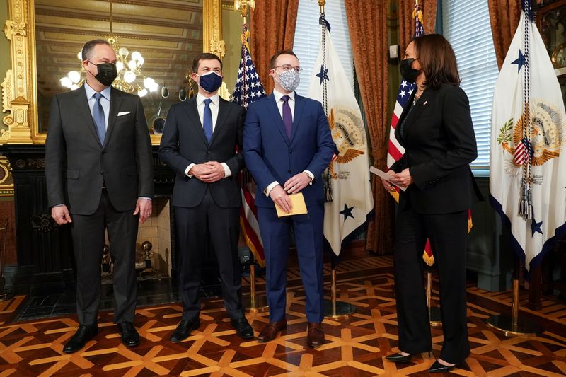 Harris performs a ceremonial swearing-in for Pete Buttigieg at the