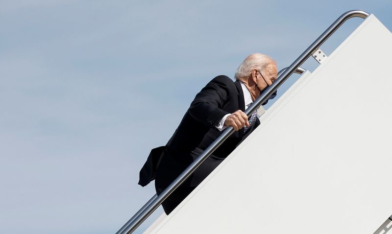 U.S. President Joe Biden stumbles on steps departs on travel