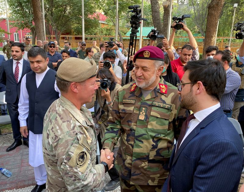 U.S. General Austin Miller, (L) shakes hand with Afghan Defense
