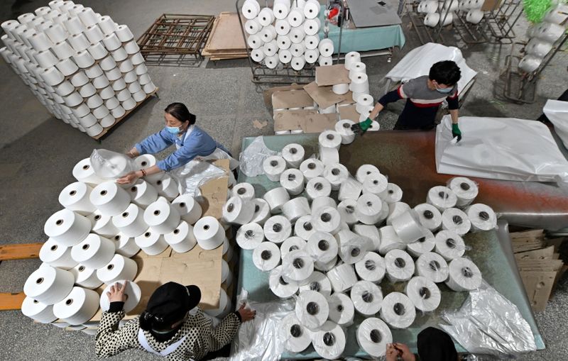 Workers are seen on the production line at a cotton