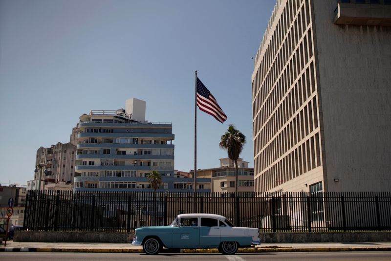 A vintage car passes by the U.S. Embassy in Havana,