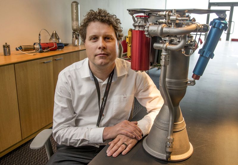FILE PHOTO: Rocket Lab CEO Peter Beck sits alongside a