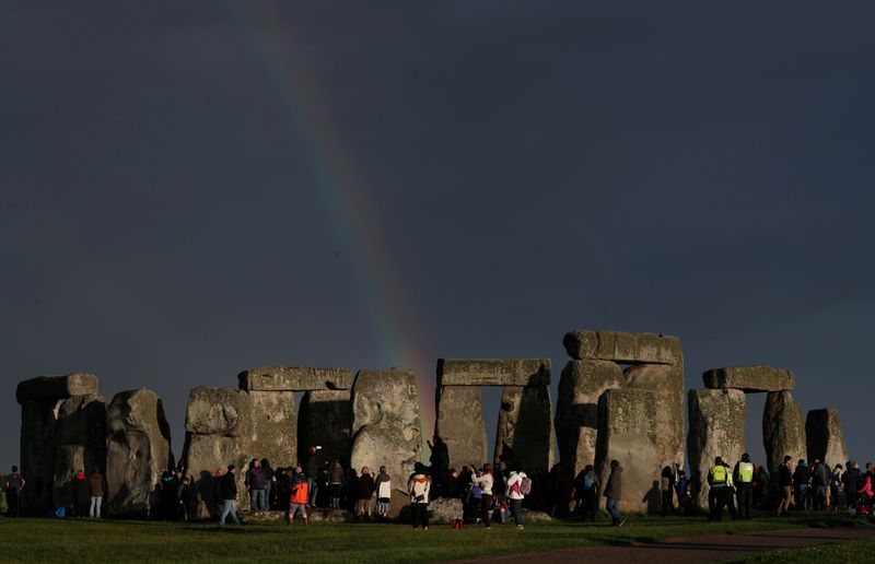 FILE PHOTO: A rainbow is seen behind the Stonehenge stone