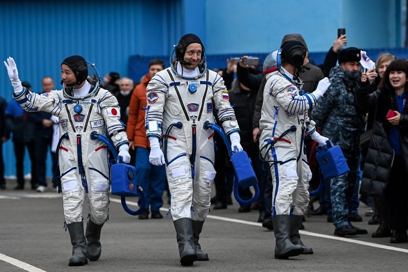 The International Space Station (ISS) crew walks after donning space