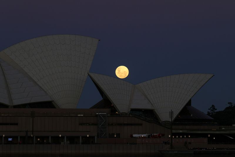 A Super Flower Moon rises behind the Sydney Opera House