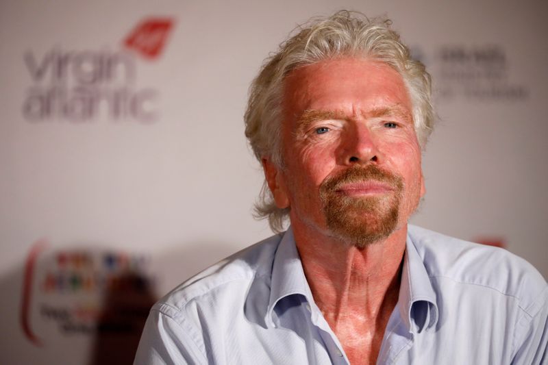 Virgin’s Richard Branson attends a news conference after landing at