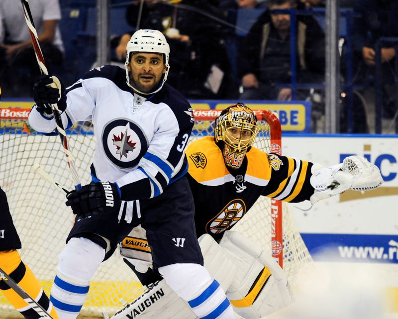 Winnipeg Jets defenceman Dustin Byfuglien screens Boston Bruins goalie Tuukka