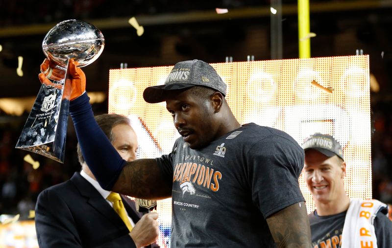 Game MVP Von Miller holds the Lombardi Trophy after the
