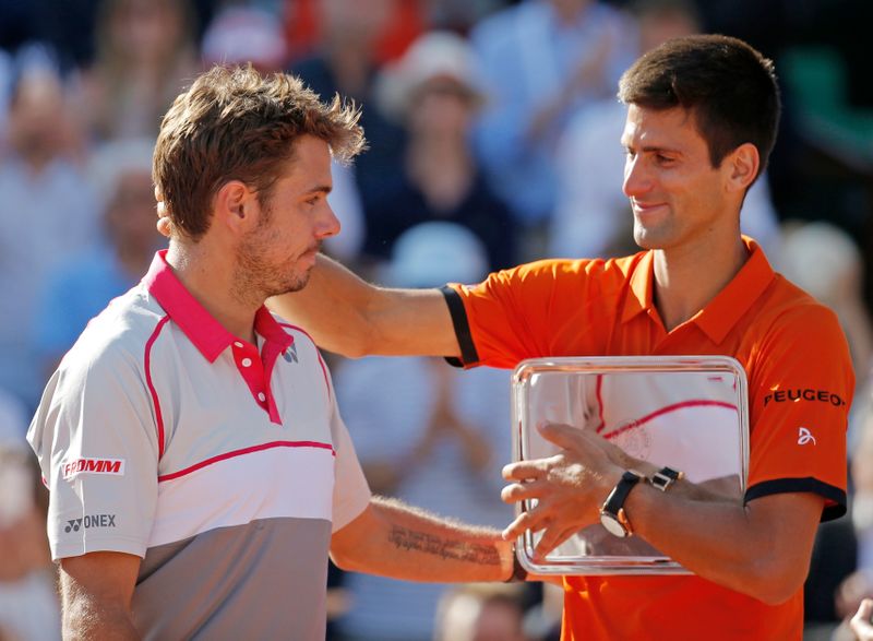 Novak Djokovic of Serbia congratulates Stan Wawrinka of Switzerland during