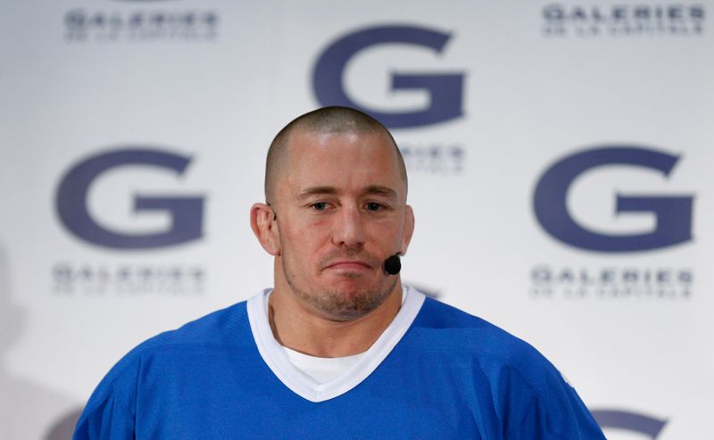 UFC welterweight champion Georges St-Pierre pauses during a news conference