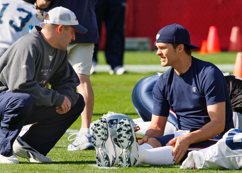 New England Patriots quarterback Tom Brady talks with offensive coordinator