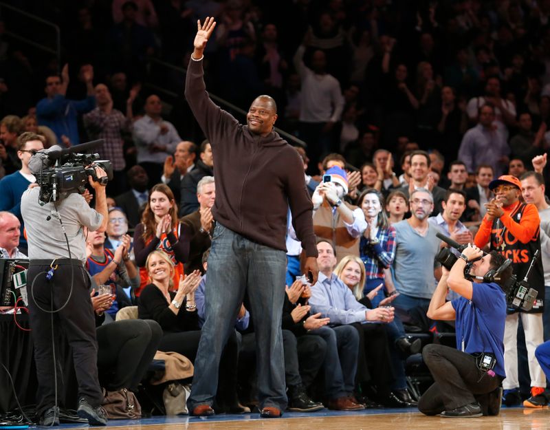 Former New York Knicks player Patrick Ewing waves to fans