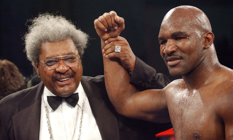 FILE PHOTO: Promoter Don King raises the hand of Evander