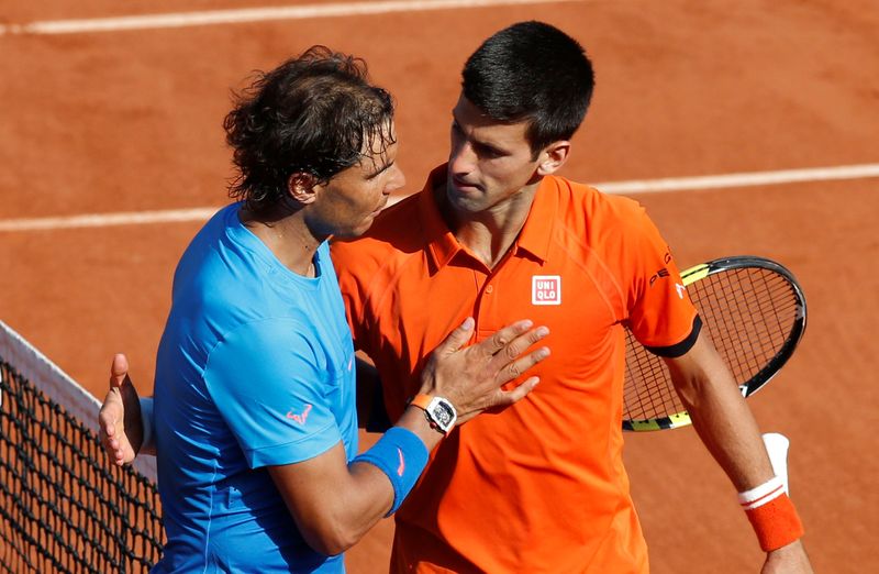 FILE PHOTO:  Novak Djokovic hugs Rafa Nadal following his