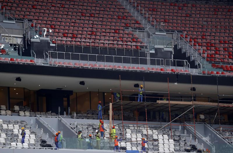 Workers are seen inside Al Bayt stadium built for the
