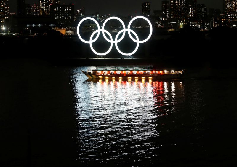 A Japanese-style tour boat sails in front of giant Olympic