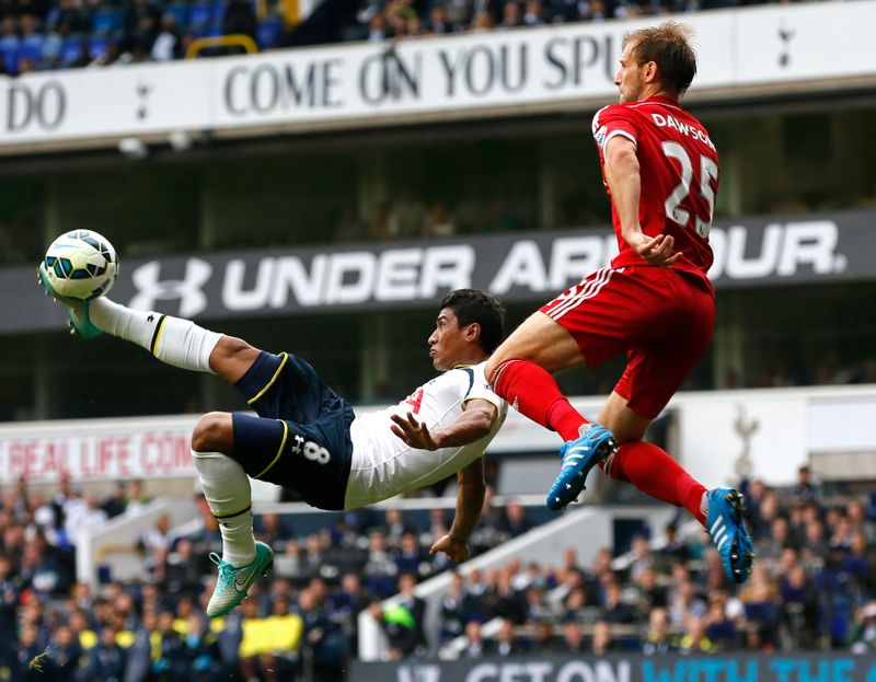 Tottenham Hotspur’s Paulinho is challenged by West Bromwich Albion’s Dawson