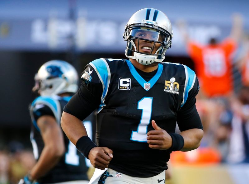 Carolina Panthers’ quarterback Cam Newton runs off the field after
