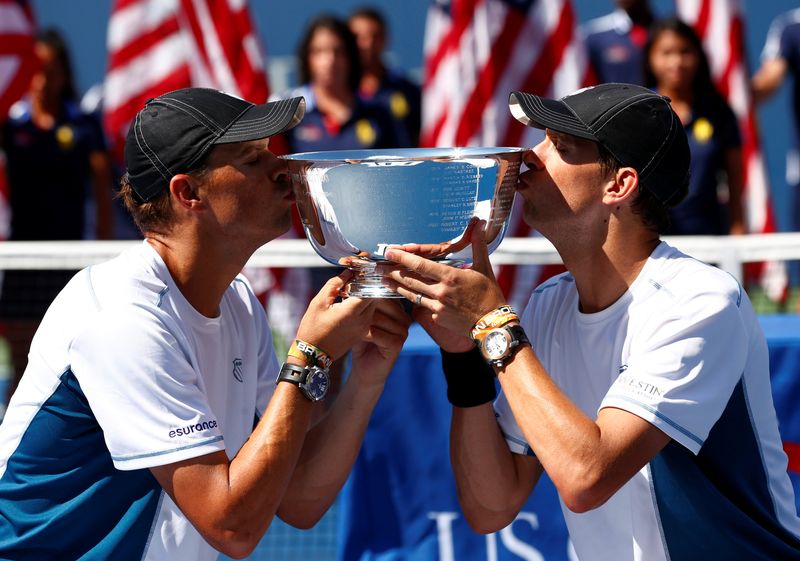 FILE PHOTO: Bob and Mike Bryan kiss their trophy after