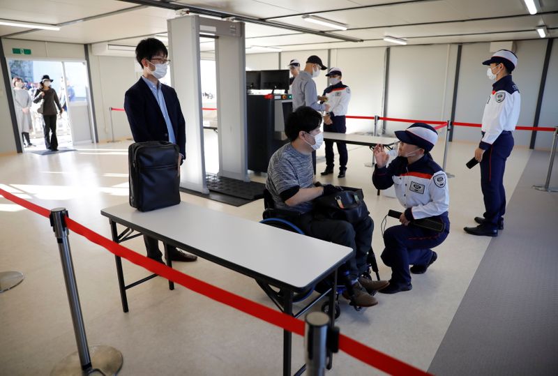 Security officers conduct a screening measures test for spectators ahead