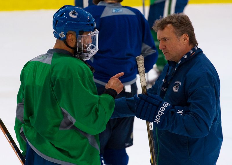 Vancouver Canucks Malhotra talks with associate coach Bowness during a
