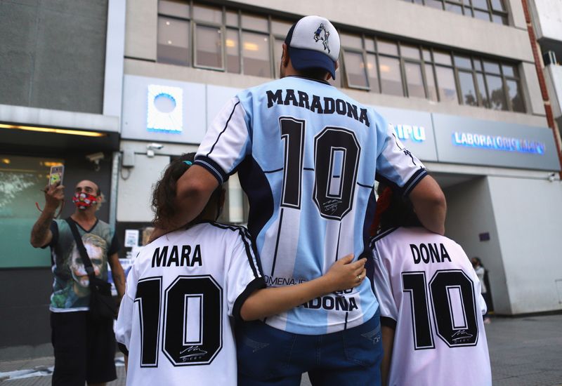 Fans of Argentine soccer great Diego Maradona pose for a