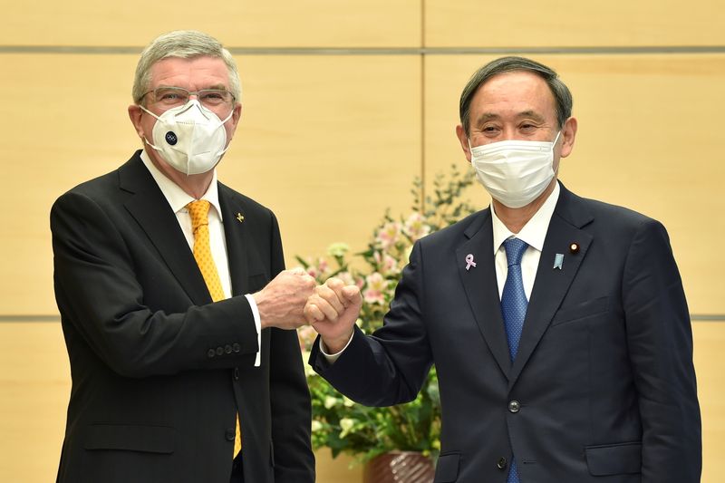 Japan’s Prime Minister Yoshihide Suga greets International Olympic Committee (IOC)