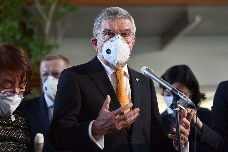 International Olympic Committee (IOC) president Thomas Bach wearing a face