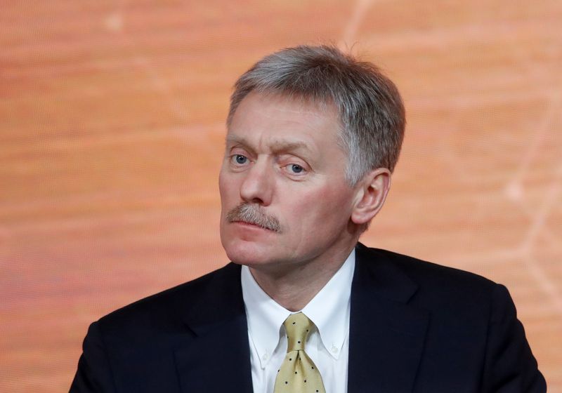 Kremlin spokesman Dmitry Peskov listens during Russian President Vladimir Putin’s