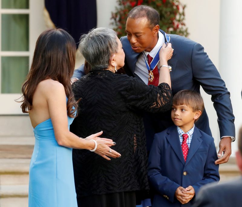 FILE PHOTO: U.S. President Donald Trump presents golfer Tiger Woods