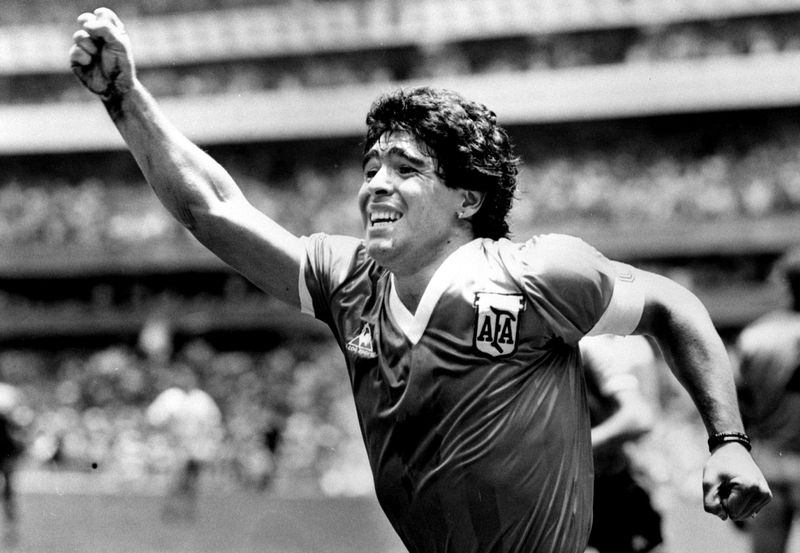 FILE PHOTO:  Argentinian star Diego Maradona raises his arm