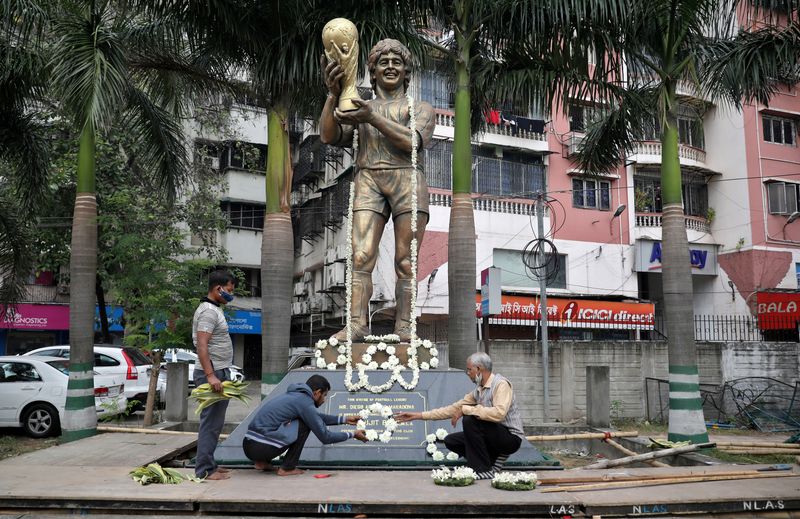 People decorate a statue of Argentine soccer great Diego Maradona