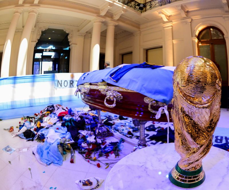 A replica of the World Cup Trophy stands next to