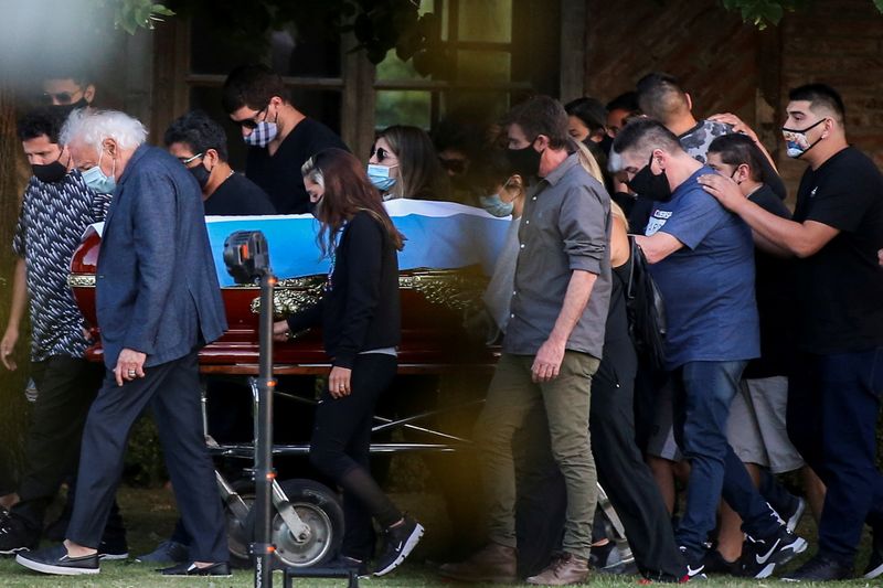 Friends and family carry the casket of soccer legend Diego