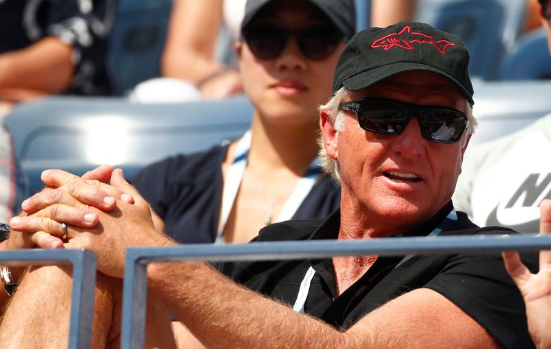 FILE PHOTO: Golfer Greg Norman of Australia watches the fourth