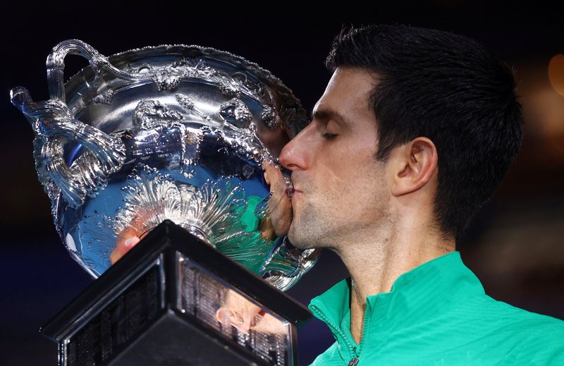 FILE PHOTO: Serbia’s Novak Djokovic kisses the trophy after winning