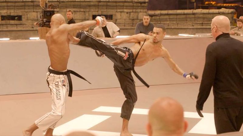 Competitors land kicks in Karate Combat in a still image