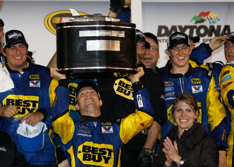 Kenseth celebrates with the Harley J. Earle trophy after winning