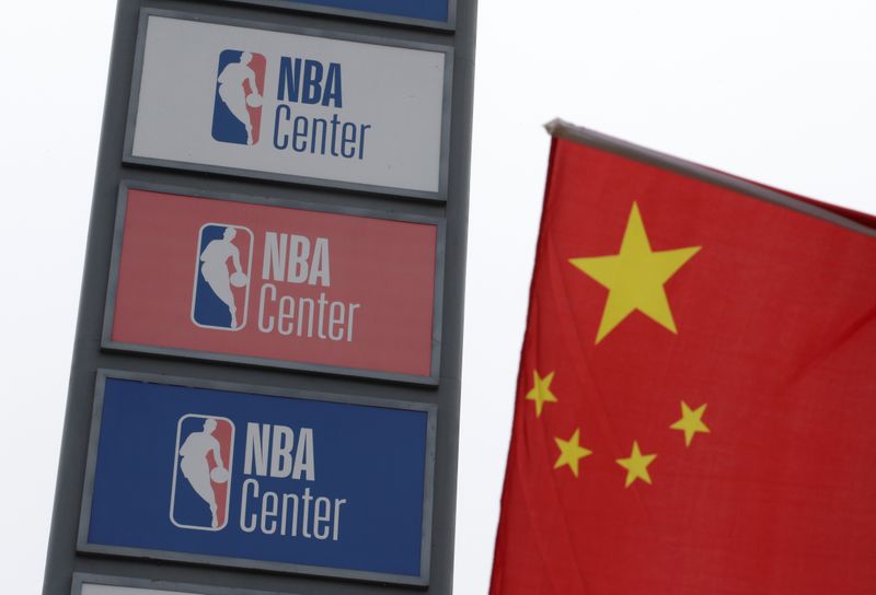 NBA logos are seen next to a Chinese national flag