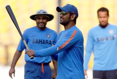 FILE PHOTO: India’s captain Dhoni holds a baseball bat as