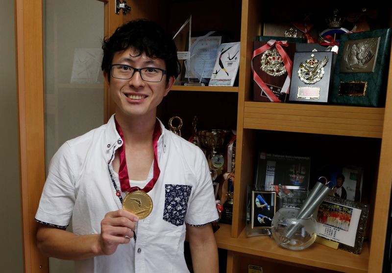 Former Japanese Olympic Trampolinist Tetsuya Sotomura poses with one of