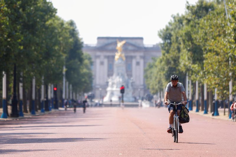 FILE PHOTO: A man cycles down The Mall, with Buckingham