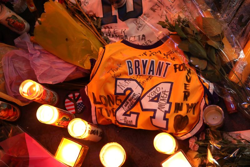 Floral and gift tributes lie outside Staples Center before a