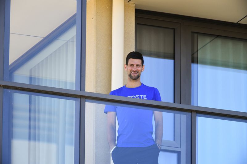 Tennis player Novak Djokovic is seen on a balcony of