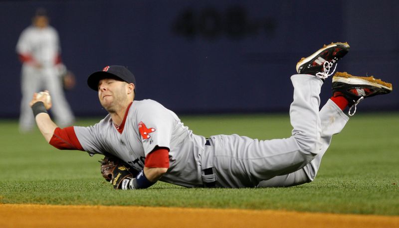 Boston Red Sox’ Pedroia dives and throws to first base