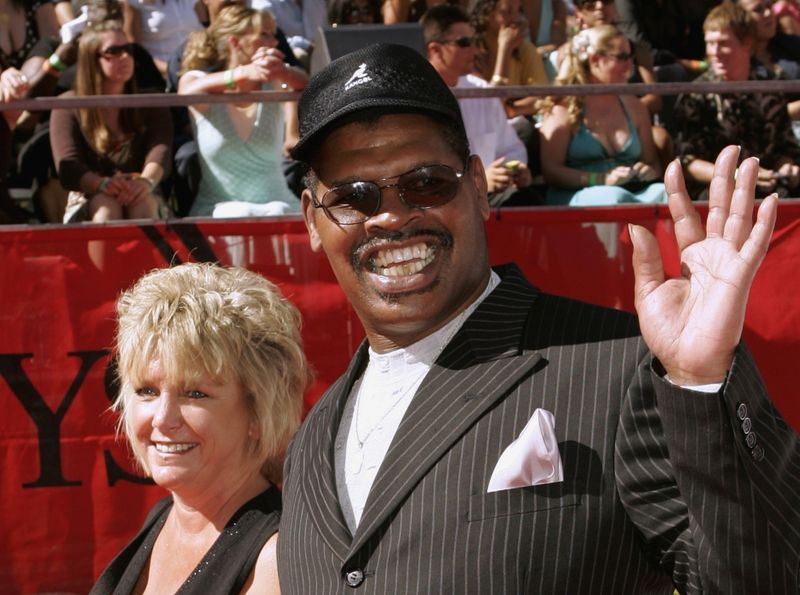 Former professional boxer Leon Spinks and unidentified guest arrive at