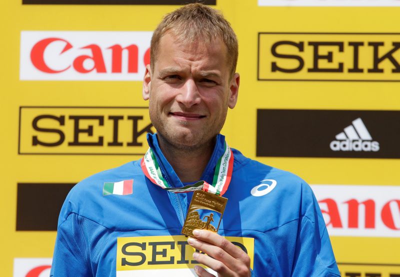 Schwazer of Italy celebrates on the podium after winning the