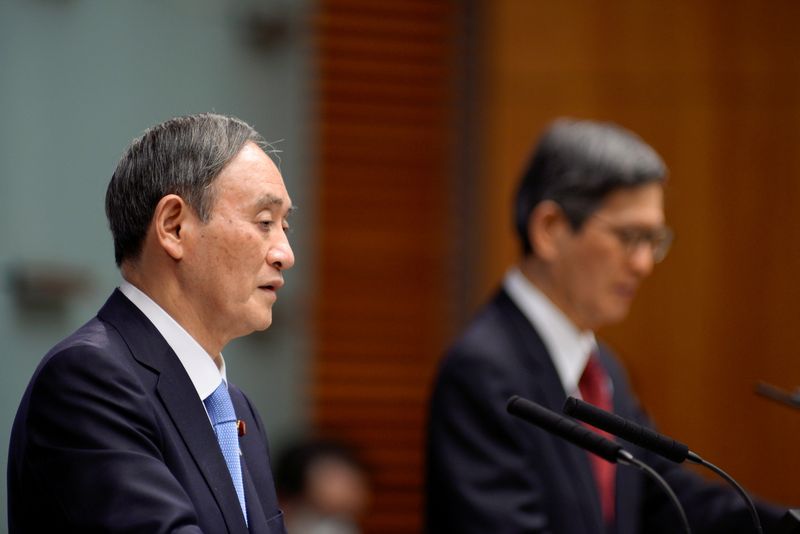 Japan’s PM Yoshihide Suga addresses a news conference on the